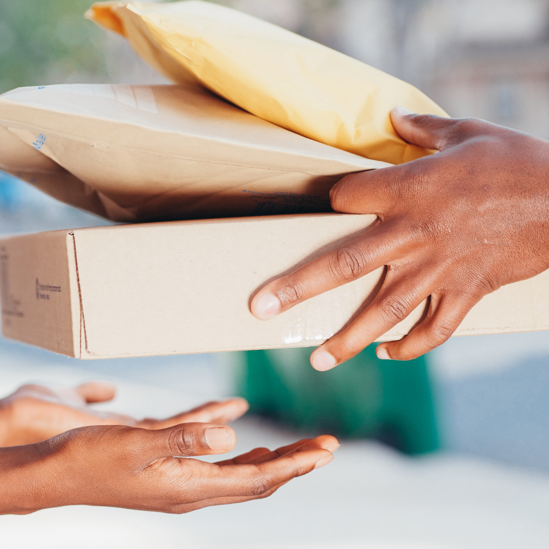 courier handing a parcel to a woman