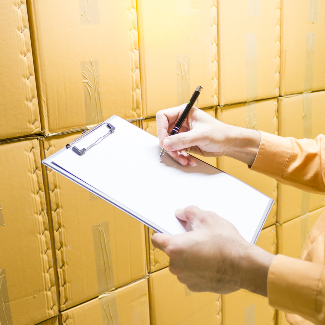 Person holding a clip board doing a stock take